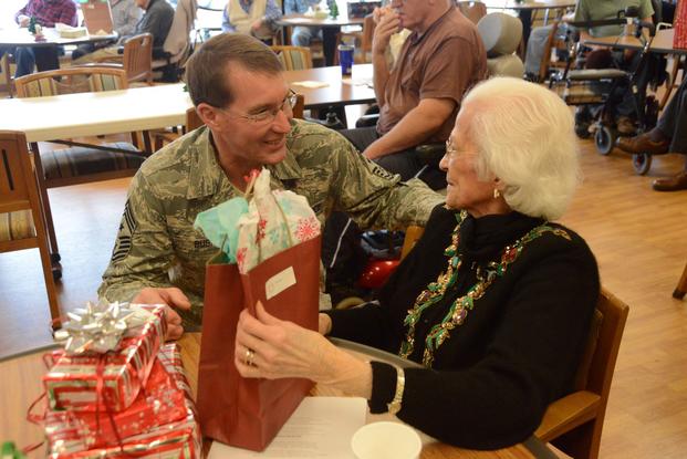 North Dakota National Guard State Command Chief visits with a veteran at a veterans home. 