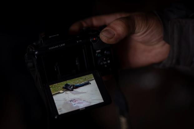 Digital camera display showing dead body. 