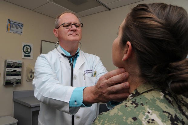 Freddie Thronson, a nurse practitioner at Naval Hospital Pensacola’s Family Medicine Clinic, checks on a patient.