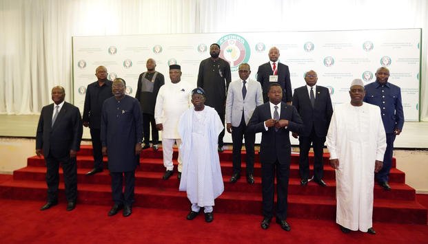Nigeria's President, Bola Ahmed Tinubu, center first row, poses for a group photo
