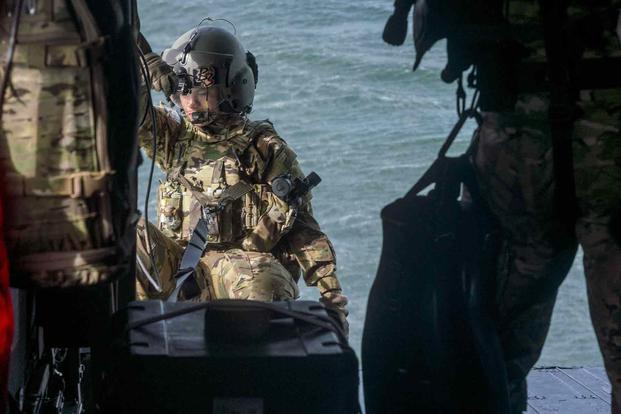 A helicopter crew member prepares for water rescue recovery during training Public Affairs)