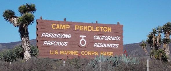 In an undated photo, the sign for Marine Corps Base Camp Pendleton, California, posted along Interstate Highway 5 reads, 'Preserving California's Precious Resources.' 
