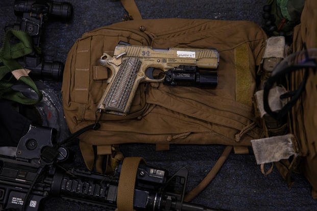 An M45A1 pistol is laid out on top of a Force Reconnaissance Marine’s loadout prior to a visit, board, search and seizure (VBSS) operation aboard the amphibious assault ship USS America (LHA 6), Philippine Sea
