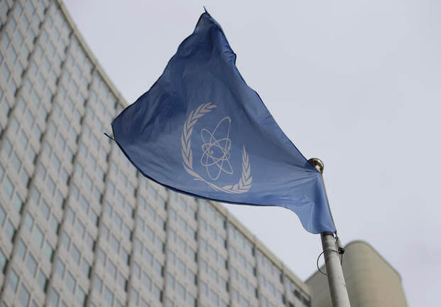 The flag of the International Atomic Energy Agency flies in front of its headquarters.