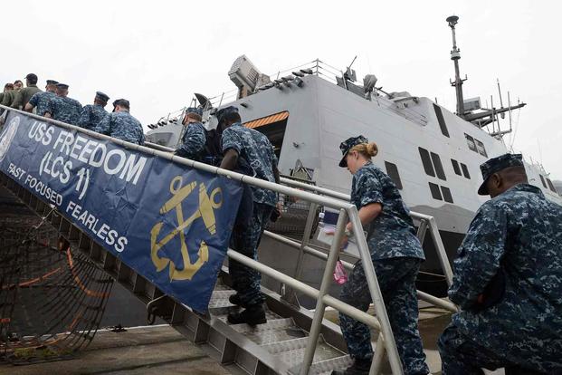 Sailors board the USS Freedom in August 2013