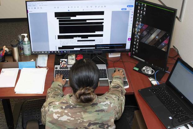 Freedom of Information Act manager, redacts a sensitive digital document 