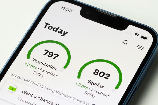 Excellent credit scores from two reporting companies are displayed on a phone screen