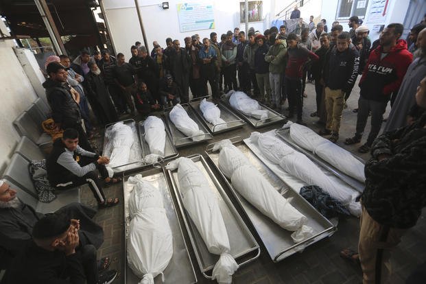 Palestinians mourn over the bodies of relatives killed in the Israeli bombardment of the Gaza Strip