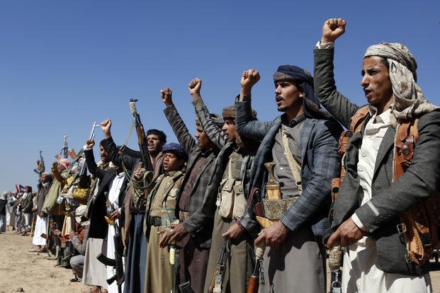 Houthi fighters and tribesmen stage a rally against the U.S. and the U.K. strikes.