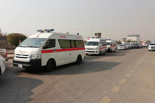 Ambulances in front of a headquarters of the Popular Mobilization Force after it was hit by an airstrike in Baghdad