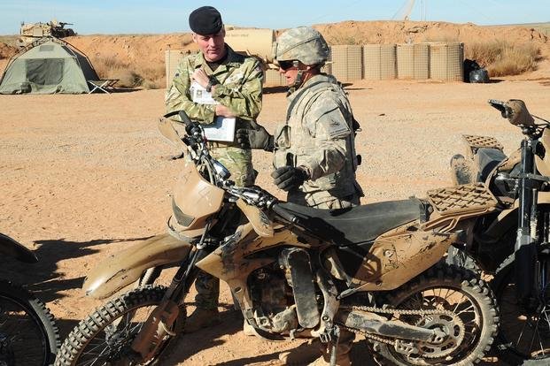 An armor crewman discusses the capability of the Christini 450cc all-wheel drive motorcycle.
