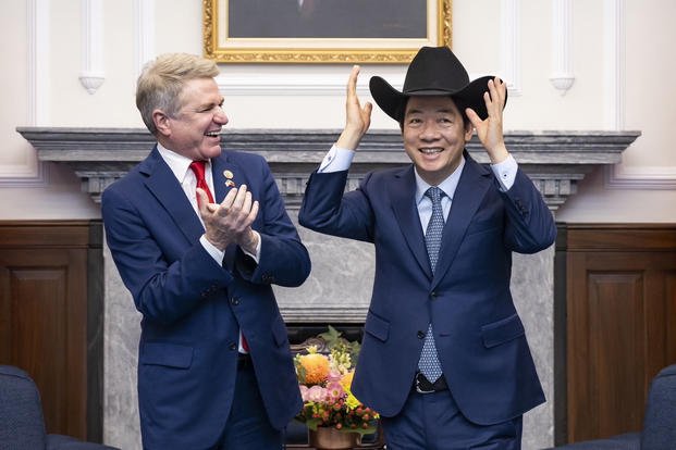 Taiwan President Lai Ching-te, right, puts on a cowboy hat given by Rep. Michael McCaul.