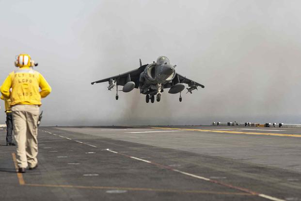 A sailor assigned to the USS Bataan participates in flight operations with a U.S. Marine Corps AV-8B Harrier II aircraft, attached to Marine Medium Tiltrotor Squadron 162, 26th Marine Expeditionary Unit, in the Gulf of Oman, Aug. 14, 2023. (U.S. Marine Corps photo by Sgt. Matthew Romonoyske-Bean)