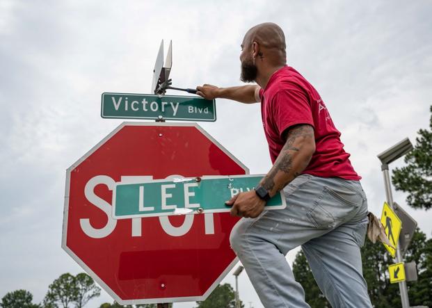 Christian Maynor replaces the Lee Boulevard street sign at Joint Base Langley-Eustis, Virginia.