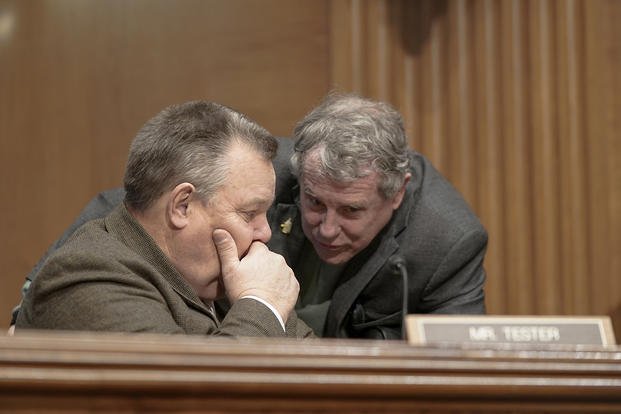 Sen. Sherrod Brown, D-Ohio, right, and Sen. Jon Tester, D-Mont., are seen during a Senate Banking, Housing and Urban Affairs Committee hearing to examine the Financial Stability Oversight Council Annual Report to Congress, Thursday, Feb. 8, 2024, on Capitol Hill, in Washington. 