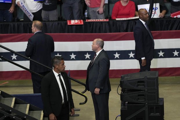 Secret Service officers look on as former President Donald Trump speaks at a campaign event 