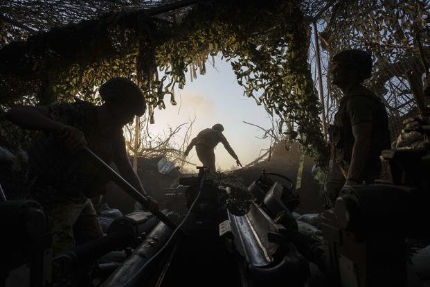 Ukrainian servicemen of 148th separate artillery brigade of the Air Assault Forces prepare a M777 howitzer