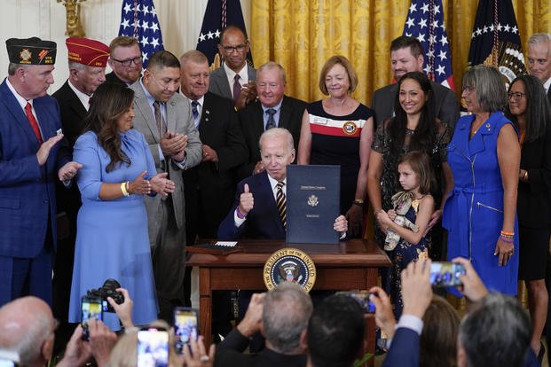 President Joe Biden holds the "PACT Act of 2022"