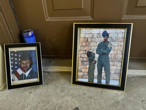 Candles and framed photos of Roger Fortson, a U.S. Air Force senior airman