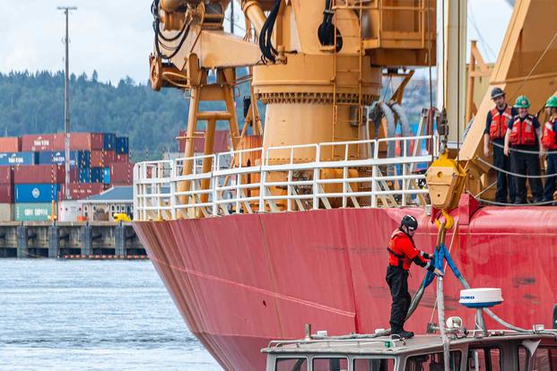 Coast Guard Cutter Healy crewmembers hoist the cutter's small boat