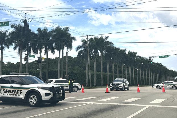 Sheriff vehicles are pictured near Trump International Golf Club.