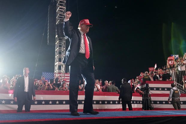 Republican presidential nominee former President Donald Trump gestures to the audience