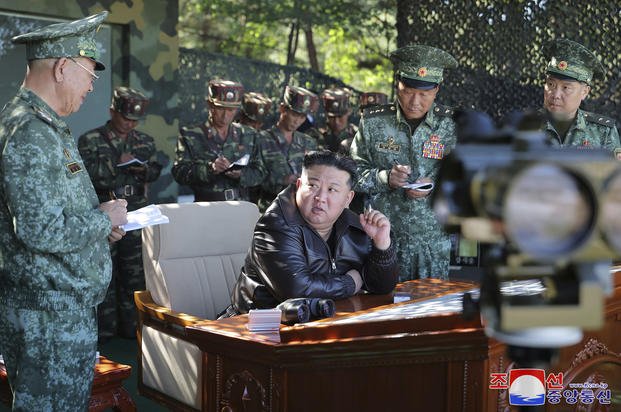 North Korean leader Kim Jong Un, center, visits a special operation forces unit