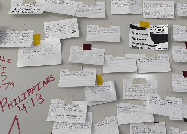Index cards taped to a board on a wall at Fort Jackson. 