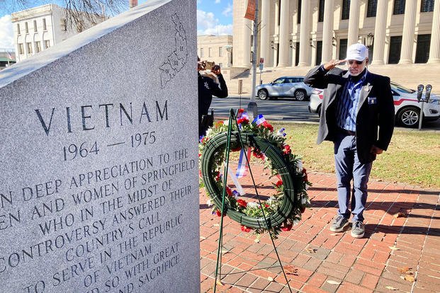 Army veteran Joseph Hendrix, who volunteers to help veterans causes, salutes after placing a wreath on the Vietnam Veterans Memorial in Springfield, Massachusetts. 