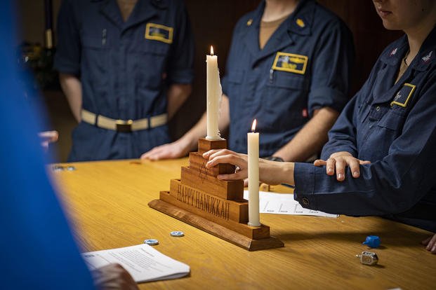 U.S. Navy sailors celebrate the first night of Hanukkah aboard the aircraft carrier USS Nimitz.