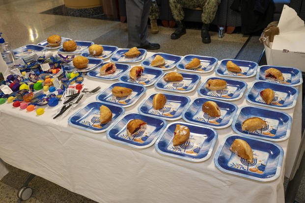 Rabbi Randy Brown, of the Department of Pastoral Care at Walter Reed National Military Medical Center, and Navy chaplain (Cmdr.) Joseph Blair Sr., clinical chaplain at WRNMMC, hosted a special ceremony marking the first day of Hanukkah on Dec. 19, 2022.