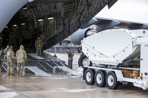 Airmen from the 138th Space Control Squadron, Peterson Air Force Base, Colorado Air National Guard, load equipment onto a C-17 Globemaster courtesy 183rd Airlift Squadron, Mississippi Air National Guard, prior to departing for temporary duty in Washington, D.C.