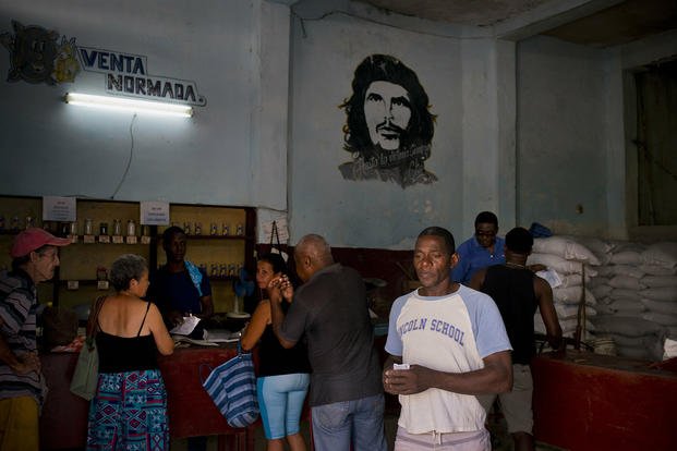 People shop for food in a government-run store in Havana.