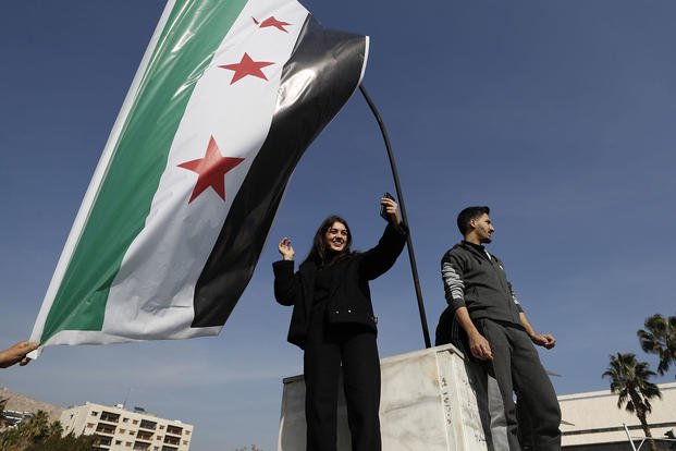 Syrians celebrate at Umayyad Square in Aleppo, Syria.