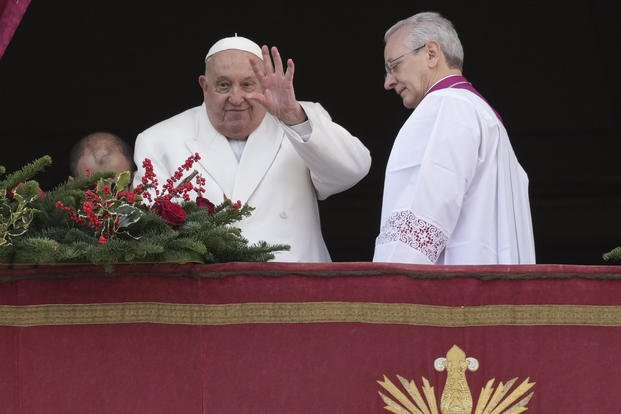 Pope Francis waves from the main balcony of St. Peter's Basilica at the Vatican.