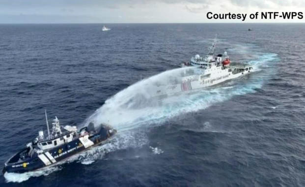 Chinese coast guard vessel, right, fires a powerful water cannon on a Philippine bureau of fisheries vessel