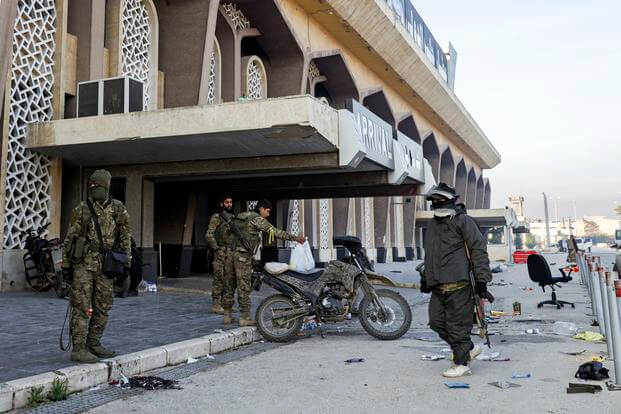 Syrian opposition fighters hang out at the arrivals gate of the Aleppo international airpot in Aleppo