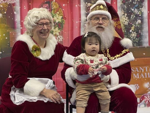 Santa and Mrs. Claus talk to a child in Yakutat, Alaska,