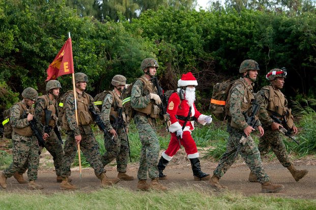 Marines and sailors from 2nd Battalion, 3rd Marine Regiment, enter the Boondocker training area at Marine Corps Base Hawaii after a 9-mile hike, Dec. 19, 2011.