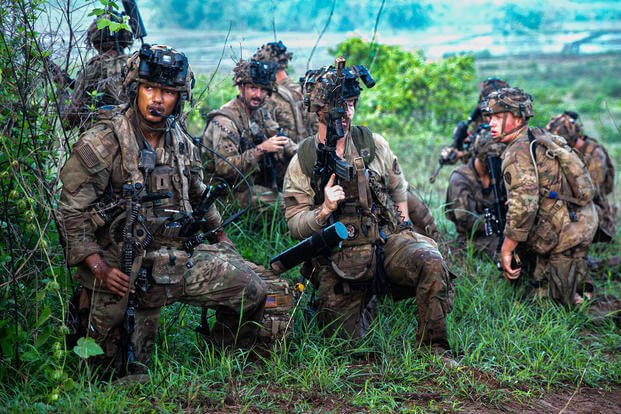 U.S. Army 1st Lt. Romello Christian, an infantry platoon leader assigned to B Company 2nd Battalion, 27th Infantry Regiment, 3rd Infantry Brigade Combat Team, 25th Infantry Division, kneels behind cover with his platoon during a simulated assault as part of the Joint Pacific Multinational Readiness Center-Exportable (JPMRC-X) exercise at Fort Magsaysay, Philippines.