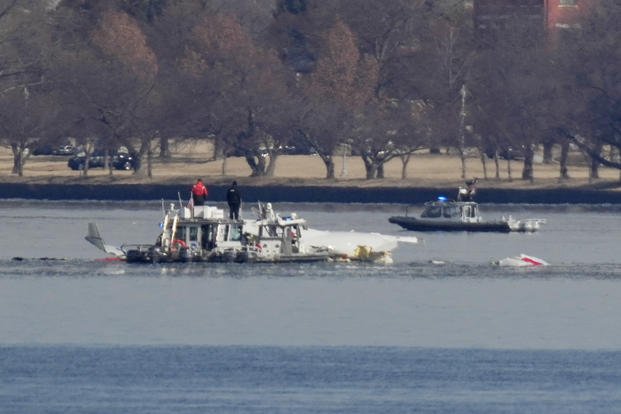Search and rescue efforts are seen around a wreckage site in the Potomac River