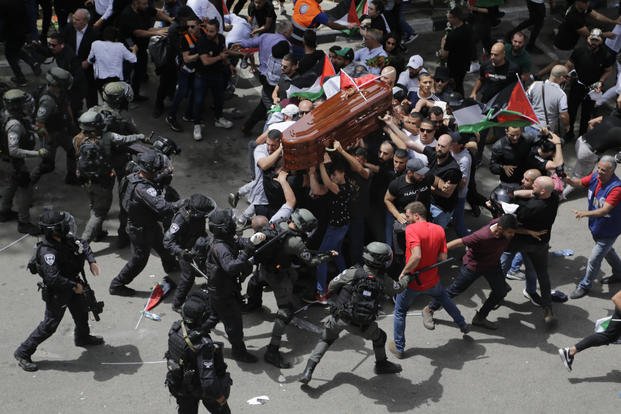 Israeli police clash with mourners as they carry the coffin of slain Al Jazeera journalist Shireen Abu Akleh during her funeral in east Jerusalem