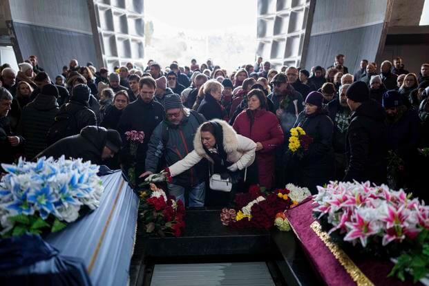 People attend the funeral ceremony of neurobiologist Ihor Zyma and his wife, biologist Olesia Sokur