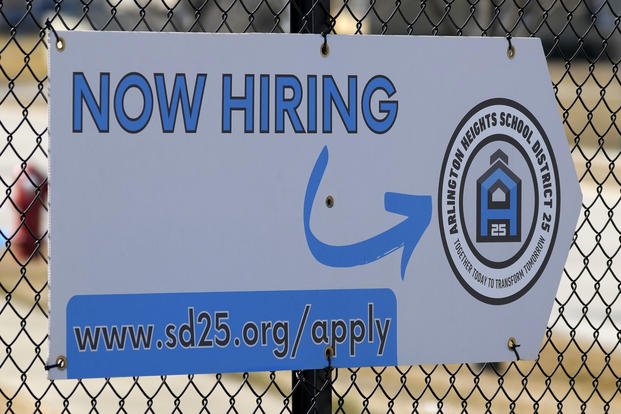 A hiring sign is displayed in Arlington Heights, Ill.