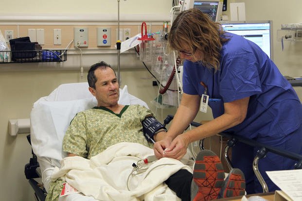 A nurse prepares liver cancer patient Crispin Lopez Serrano, a native of Mexico, for an endoscopy at a hospital in Clackamas, Oregon.