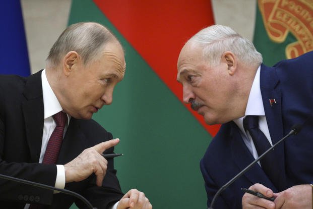Russian President Vladimir Putin, left, and Belarusian President Alexander Lukashenko talk