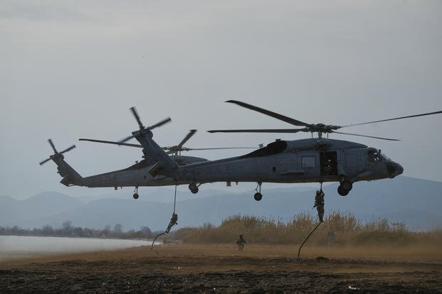 Special forces from Spain land on a beach from a military helicopter as they participate in the Steadfast Dart 2025 exercise