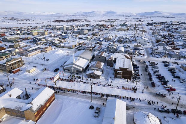 ome, Alaska, awaits the first Iditarod Trail Sled Dog Race musher 