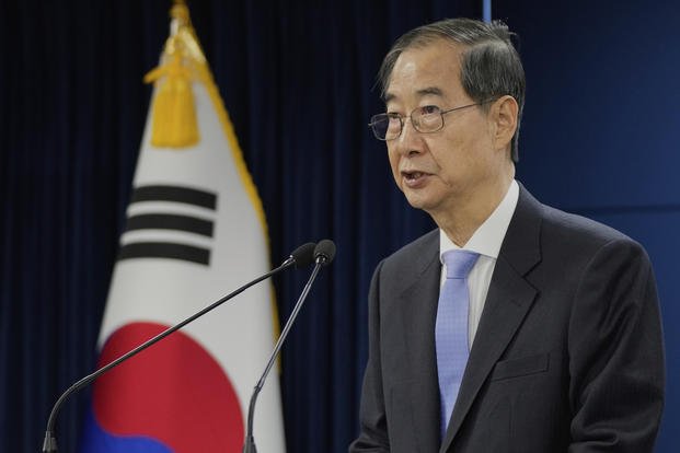 South Korean acting President Han Duck-soo speaks during a briefing at the Government Complex