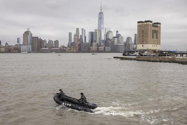 A New York Police Department scuba team looks for debris.